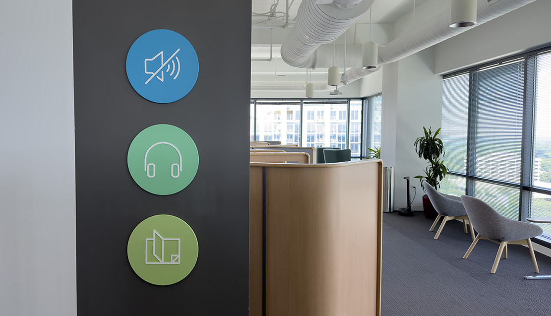 Icons used as informational signage in an office space, indicating that the space is a quiet zone.