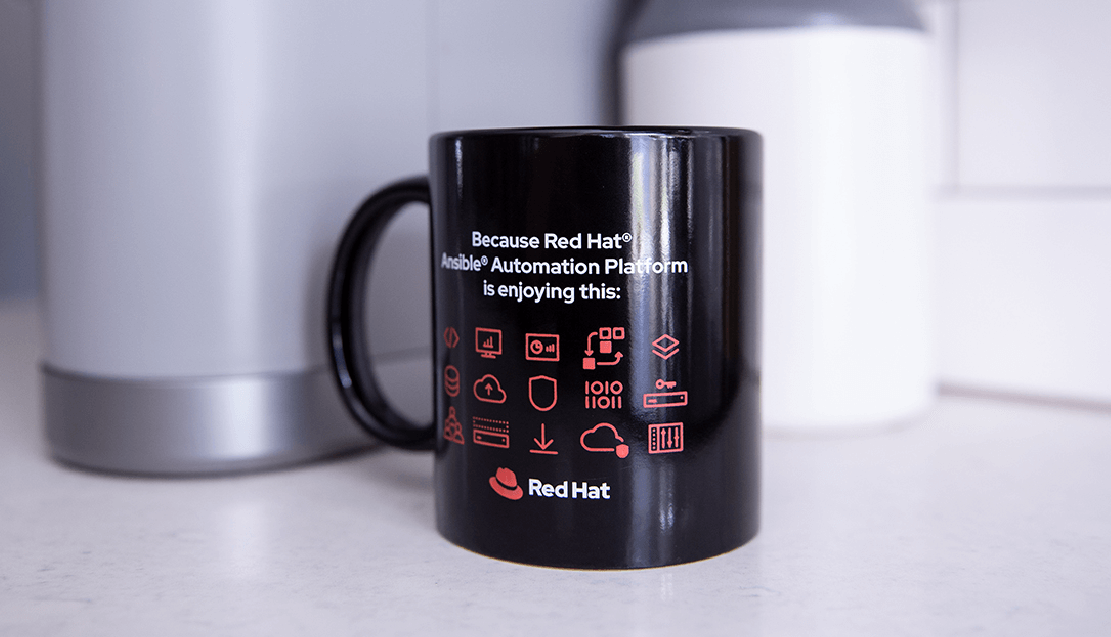 A photograph of a mug with the text “Because Red Hat® Ansible® Automation Platform is enjoying this” and icons representing automation processes