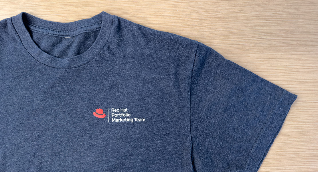 Red Hat Portfolio Marketing Team logo on a t-shirt.